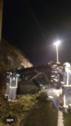 Bomberos con el coche accidentado en la AS-15 en Tineo.