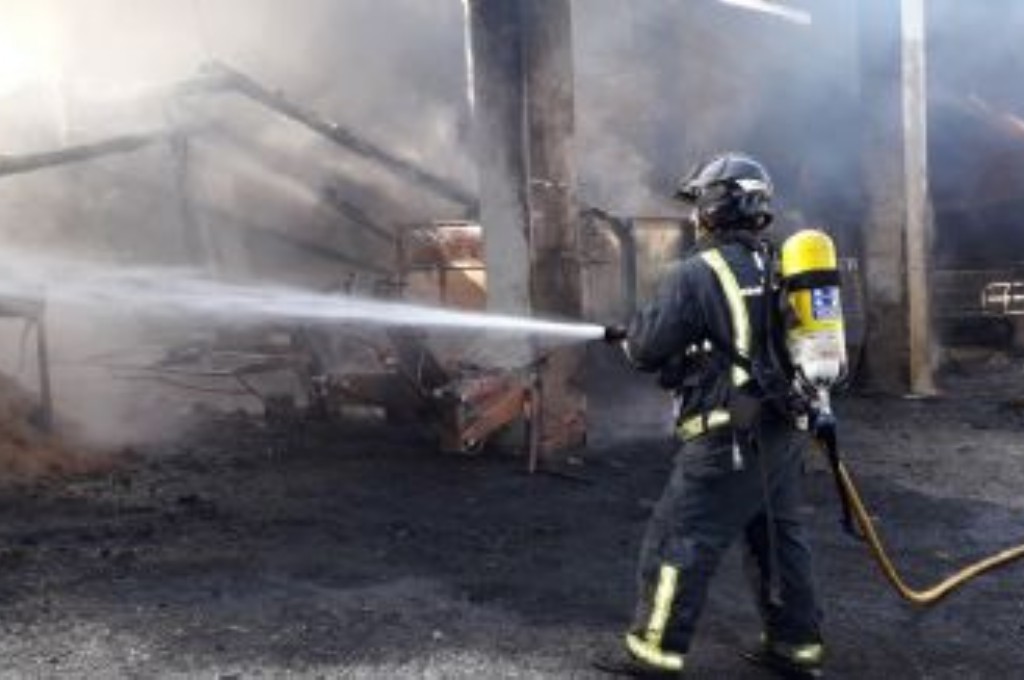Bombero trabajando en el incendio de una cuadra en Vegadeo.