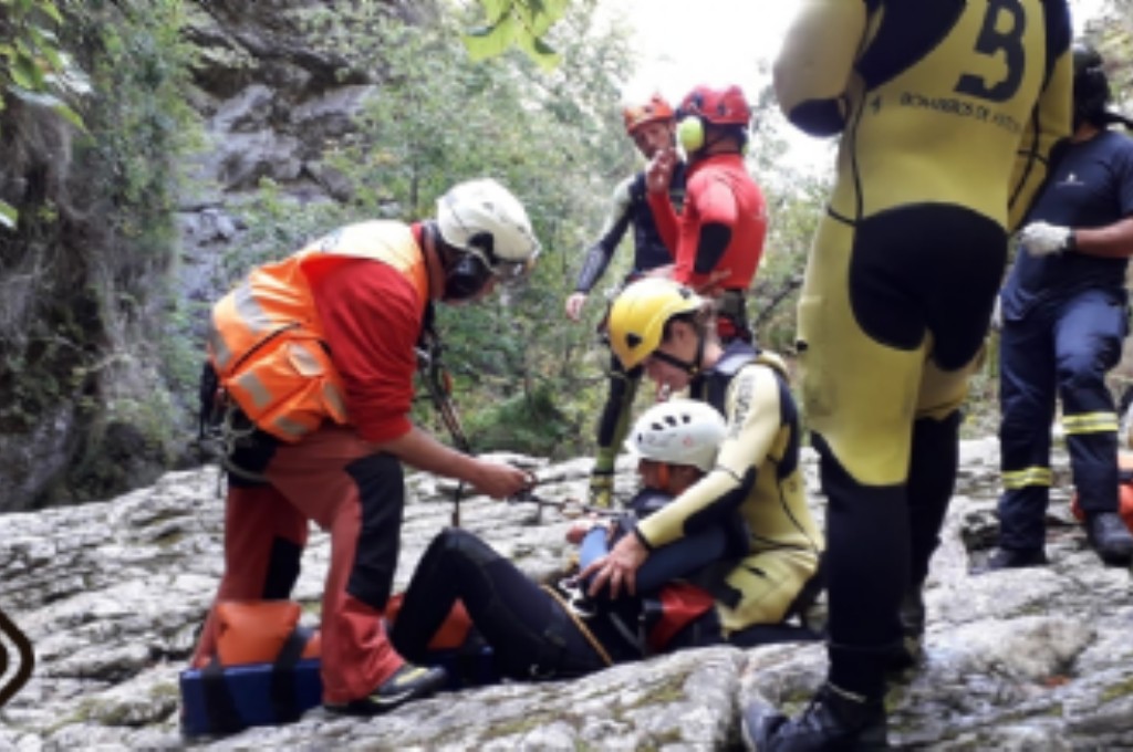 Bomberos de Cangas de Onís y Grupo de Rescate con la afectada en Amieva.